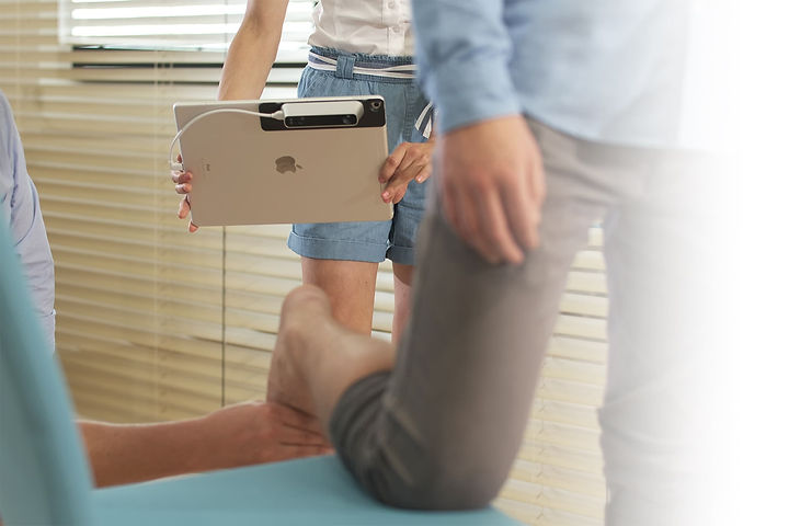 clinician using an ipad to scan a patients foot
