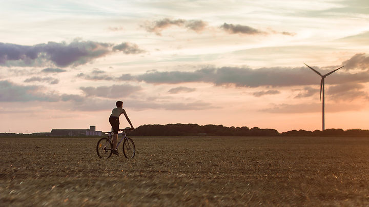 a cyclist riding through a field