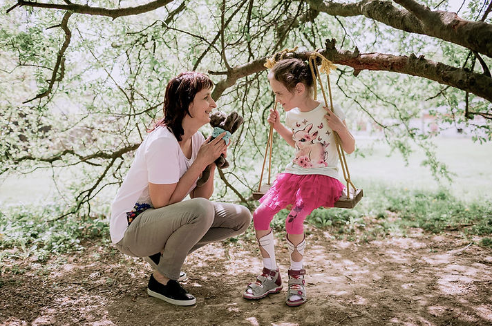 mother and daughter playing, child wearing afo brace